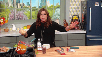 GIF of Rachael Ray eating and sprinkling ingredients into a skillet
