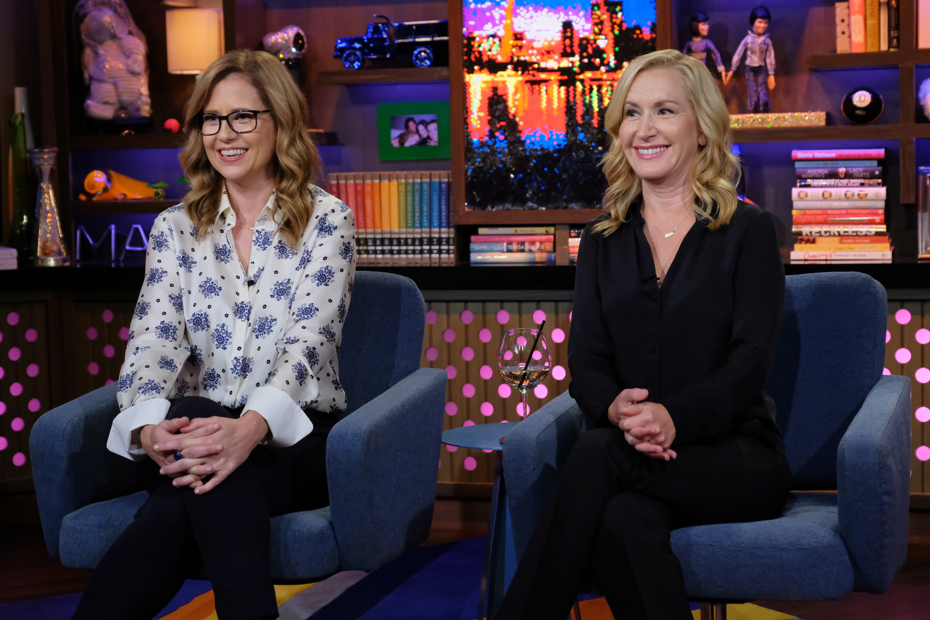 Jessica Fischer and Angela Kinsey sit next to each other while appearing on Watch What Happens Live With Andy Cohen