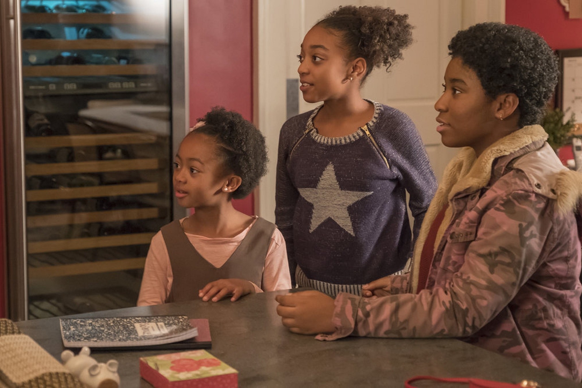 This Is Us characters Annie, Tess, and Deja at a kitchen counter