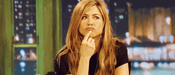 Jennifer Aniston as Rachel ponders something as she touches her chin