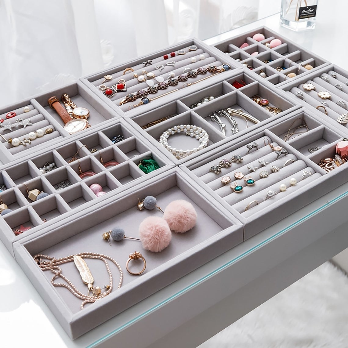 A variety of the jewelry trays filled with jewelry