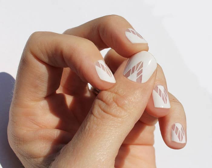 A hand showing the nail wrap design