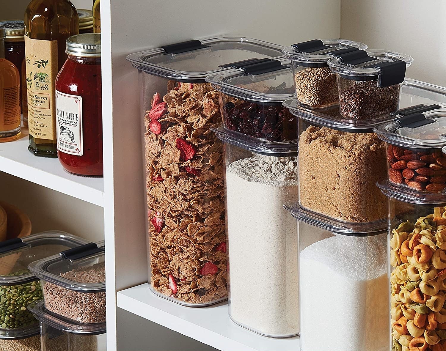 Food storage containers stacked in a pantry filled with ingredients 