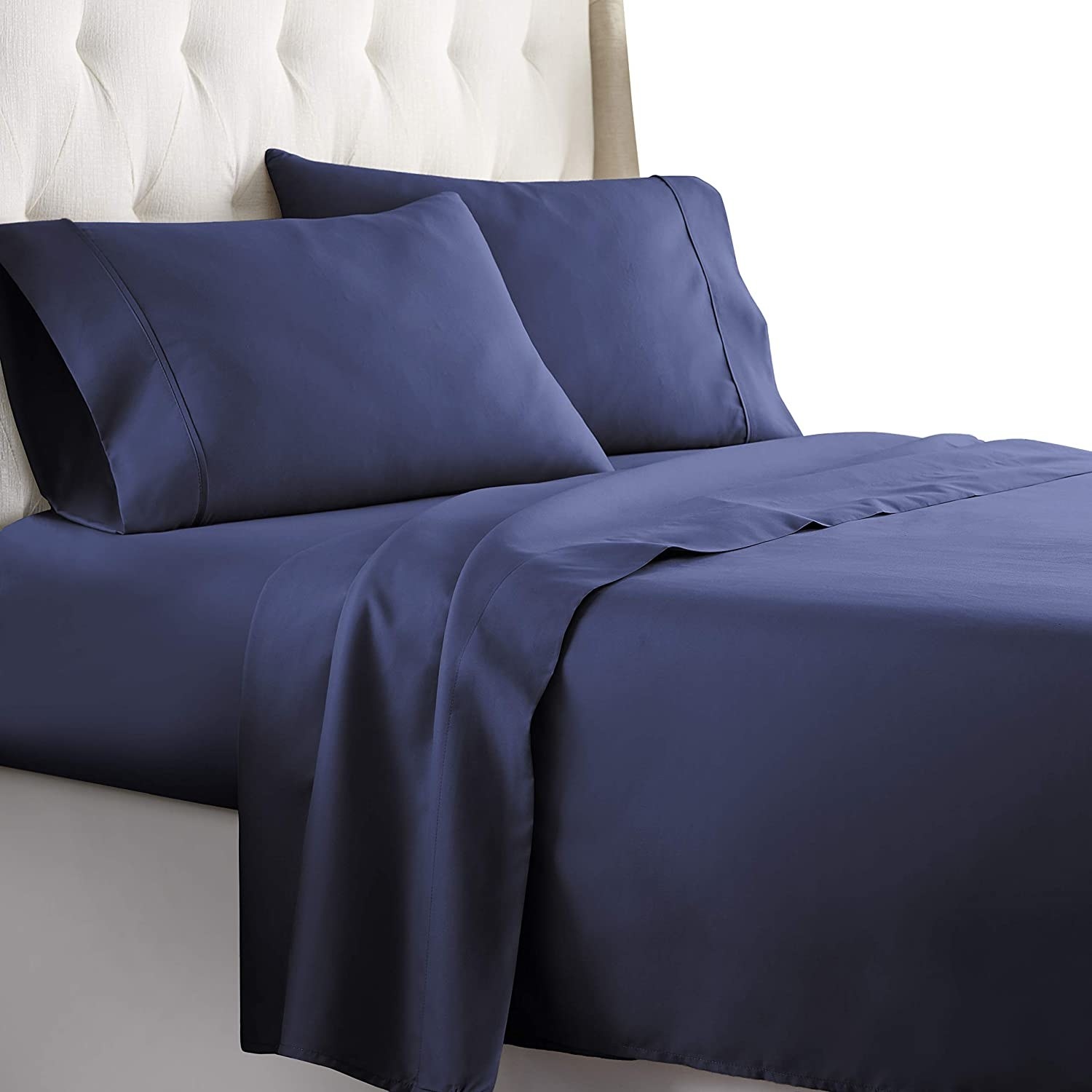 dark blue sheets and pillowcases on a bed