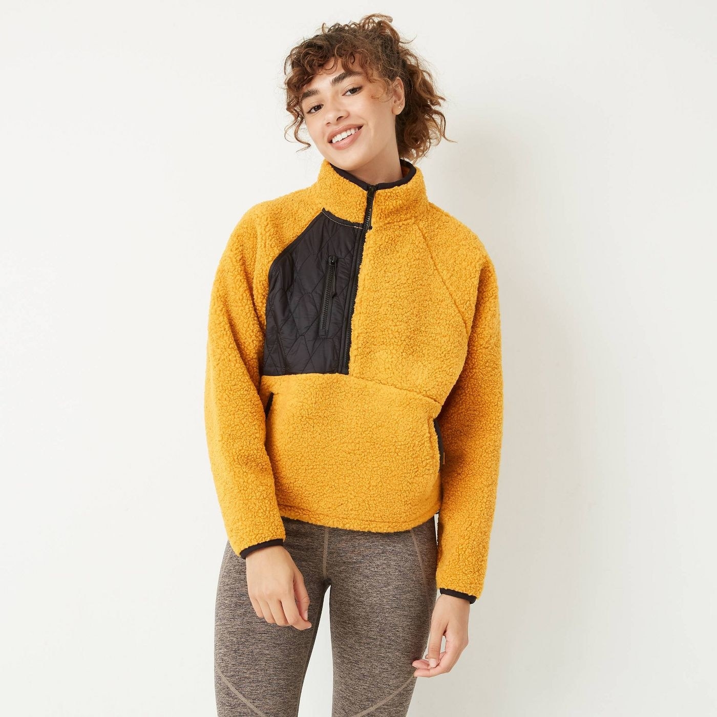 model wearing yellow and black fleece