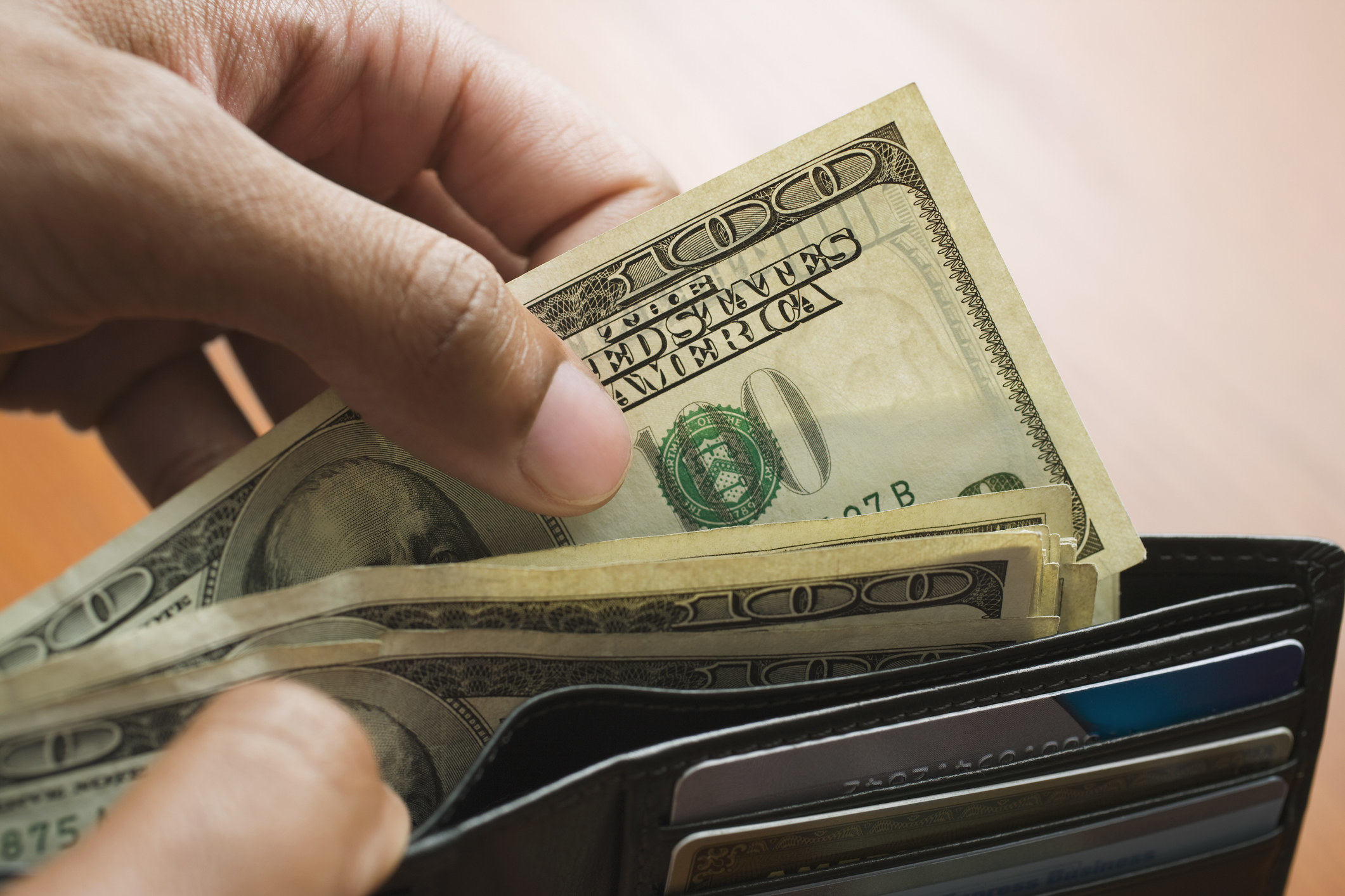 Person pulling money out of a wallet