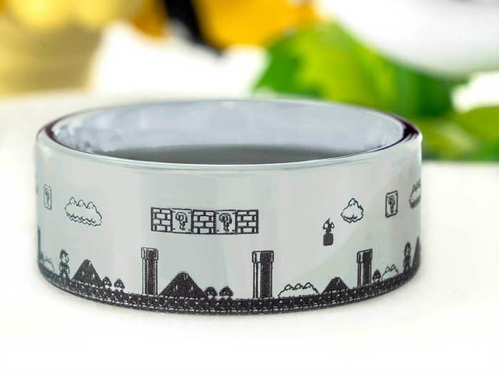 A silver band ring engraved to look like a side-scrolling level of Super MArio Bros 