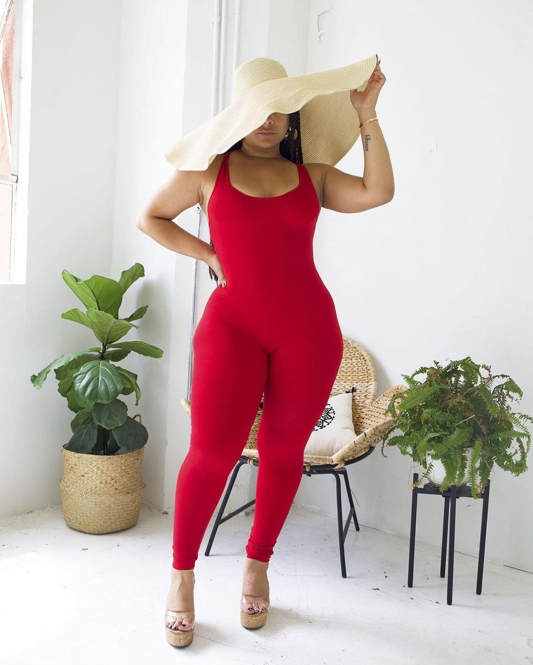 A model wearing a jumpsuit in red