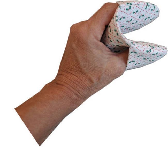 A model using a tiny oven mitt that just covers their fingers and thumb 