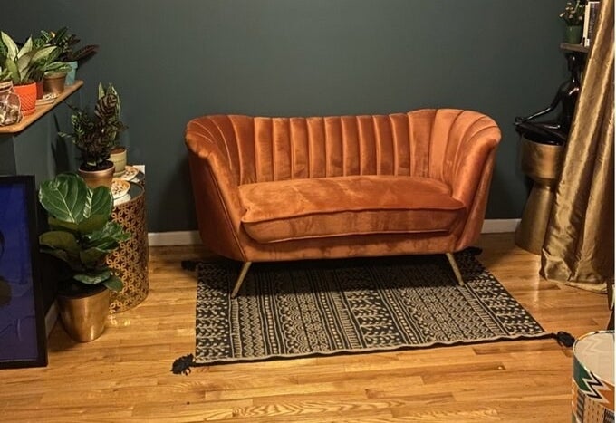 Reviewer&#x27;s picture of the loveseat, which has a back that wraps around the sides and slightly into the front, in almost a &quot;C&quot; shape