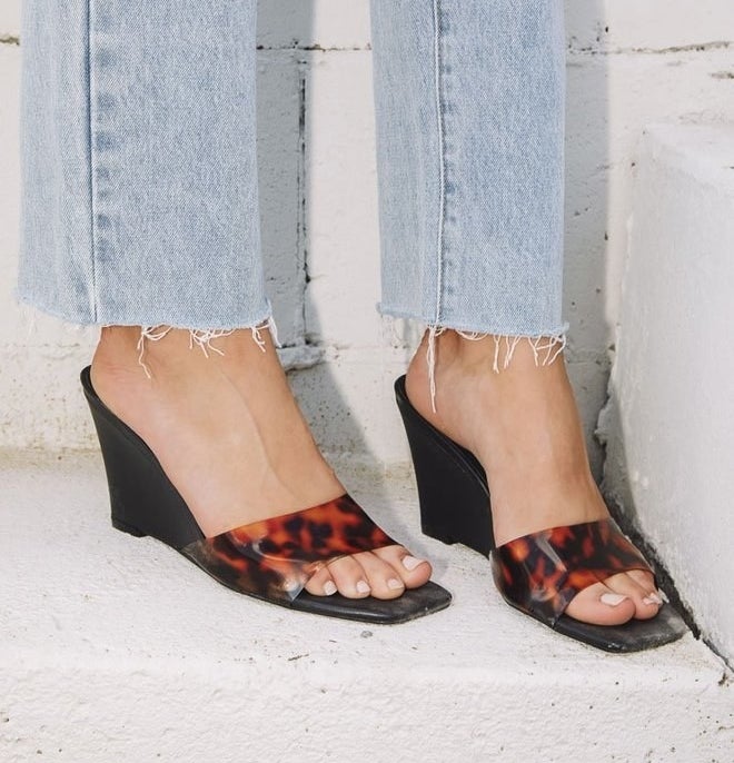 the black wedge heels with brown and black tortoise opaque strap across the toes