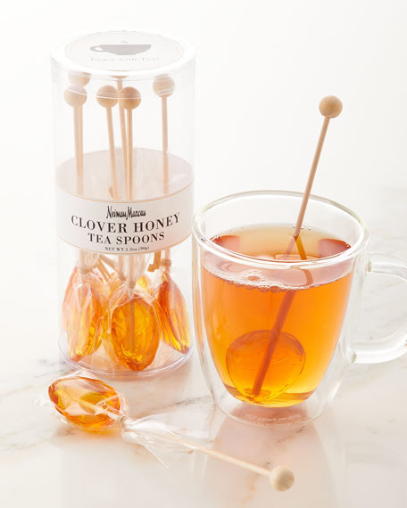 one of the honey spoons being used in a cup of tea