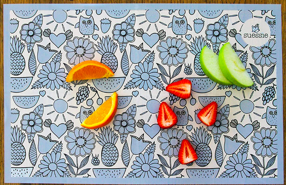 Patterned rectangular placemat with sliced fruit on top 