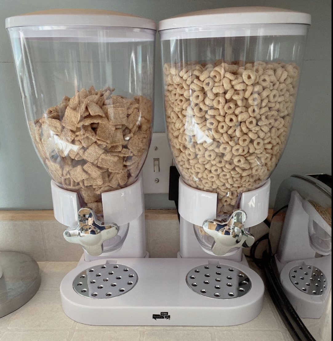 Reviewer image of double cereal dispenser with transparent body and white base 