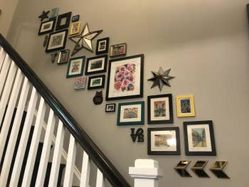 Reviewer's gallery wall of black frames hung using Command Strips