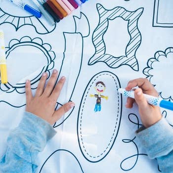 Child drawing in frame patterned color-in tablecloth 