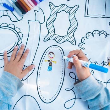 Child drawing in frame patterned color-in tablecloth 