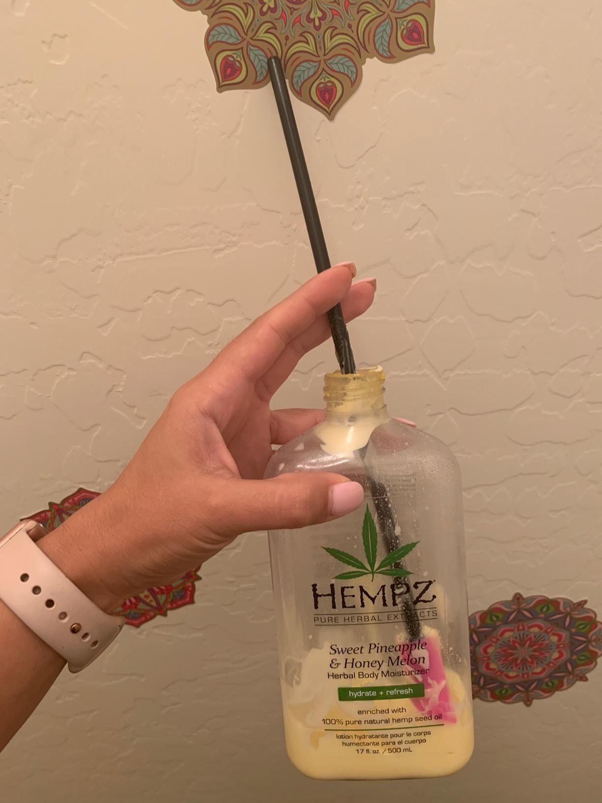 Reviewer digging in lotion with spatula