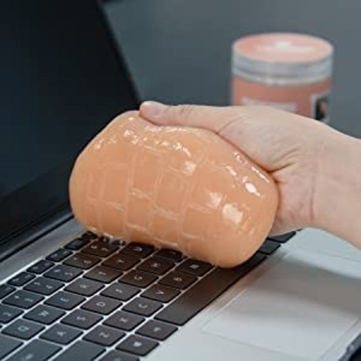 Model using putty to clean keyboard