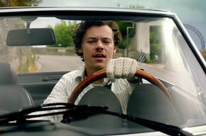 Harry Styles driving a car in the golden music video