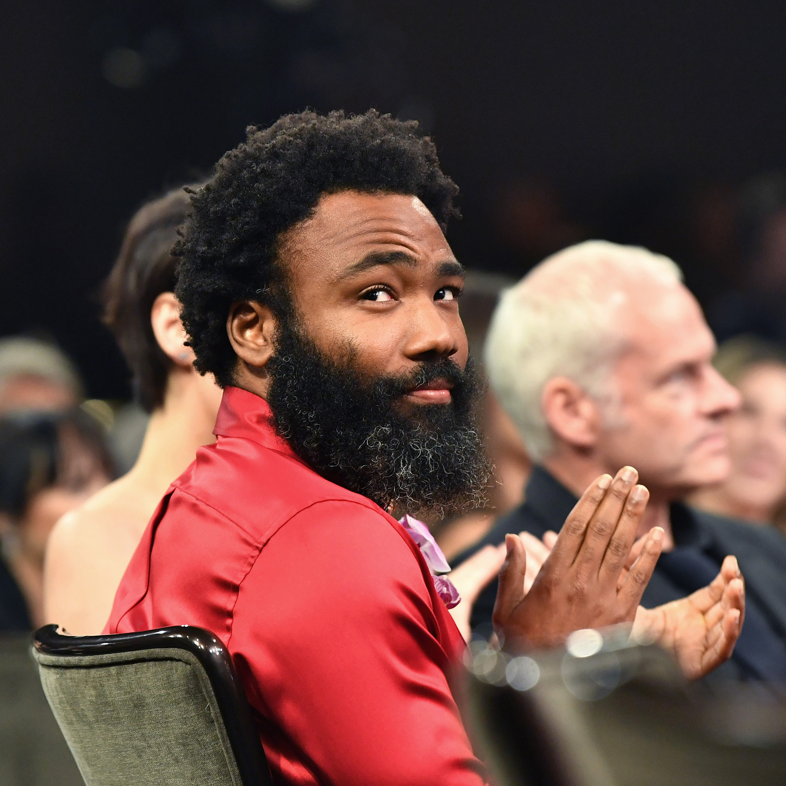 Donald Glover looks over his shoulder while sitting down at the British Academy Brittania Awards in October 2019