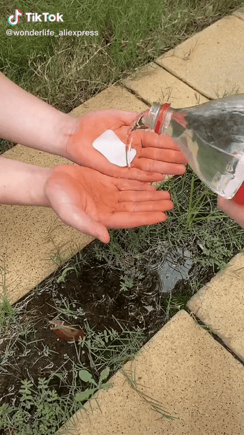 Model using soap paper with water to clean hands outside