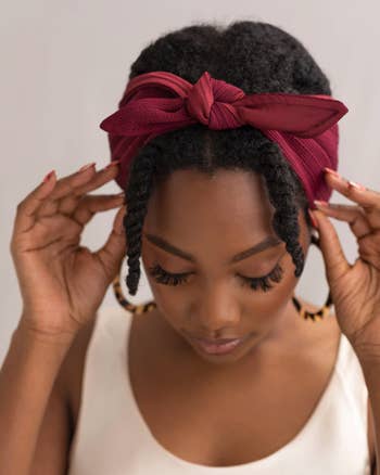 model with kinky hair wearing the bandie in red 