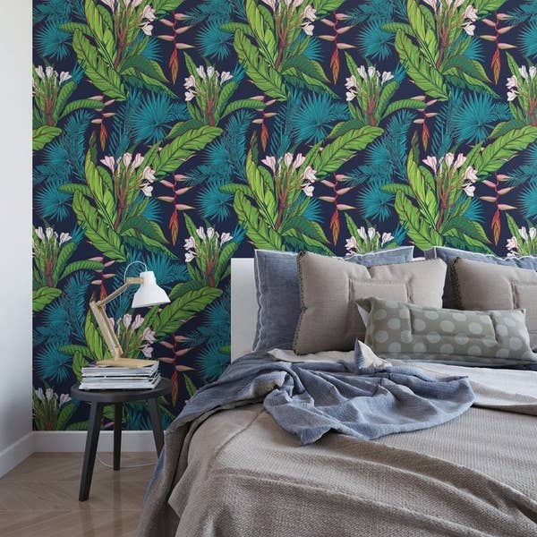 blue, green, and pink banana leaf-print adhesive wallpaper next to bed