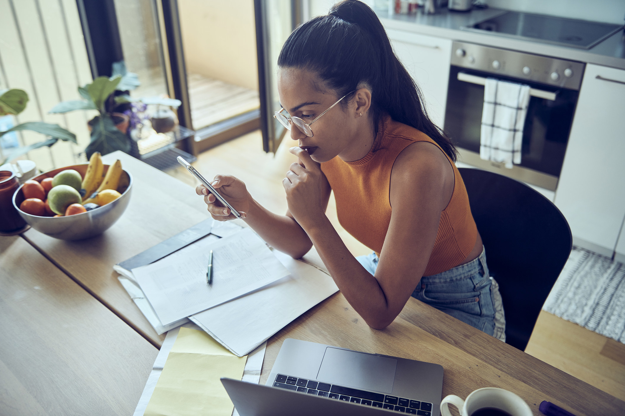 Woman looking at bills 