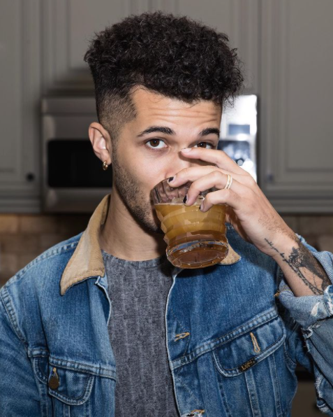 Jordan Fisher sipping on a cocktail