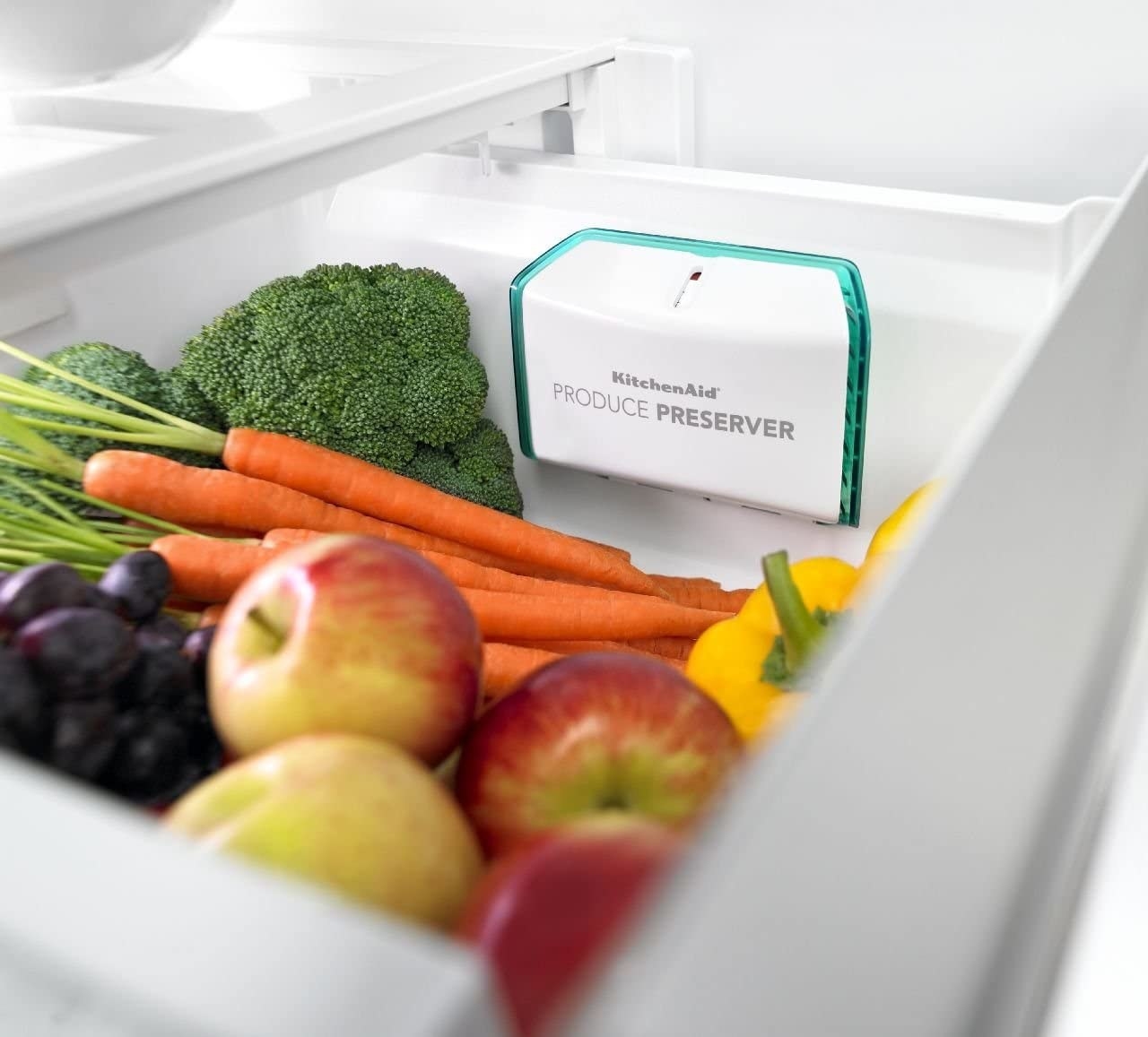 the produce preserver in a fridge bin next to veggies