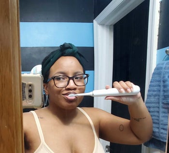 BuzzFeed writer Taylor Steele brushes her teeth with the Dr. Brite electric sonic toothbrush