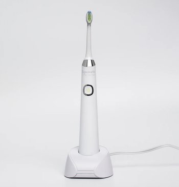 the electric sonic toothbrush in its charging station