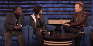 A gif of Taraji P. Henson on Conan&#x27;s talk show showing off an engagement ring 
