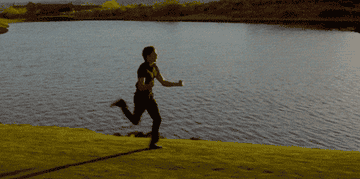 A young man dancing and spinning while he runs.