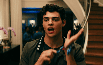 Peter Kavinsky snapping a scrunchie on his wrist