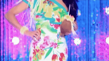 GIF of Bianca in a tropical gown walking down the Drag Race runway and taking of her sunglasses