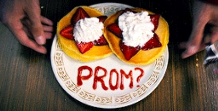 A plate of pancakes with &quot;prom?&quot; written on it