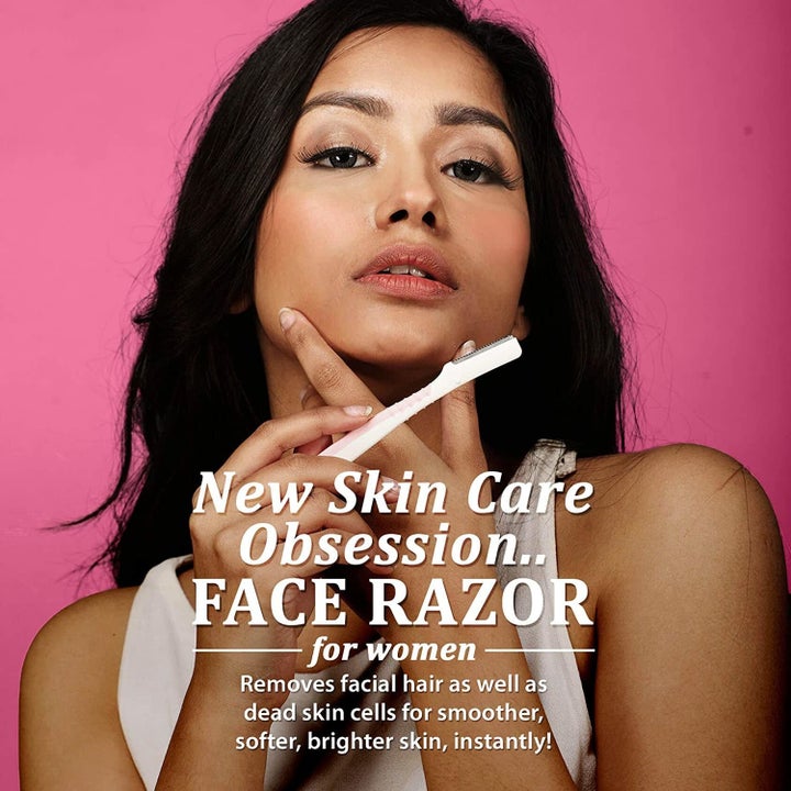 A woman using the facial razor