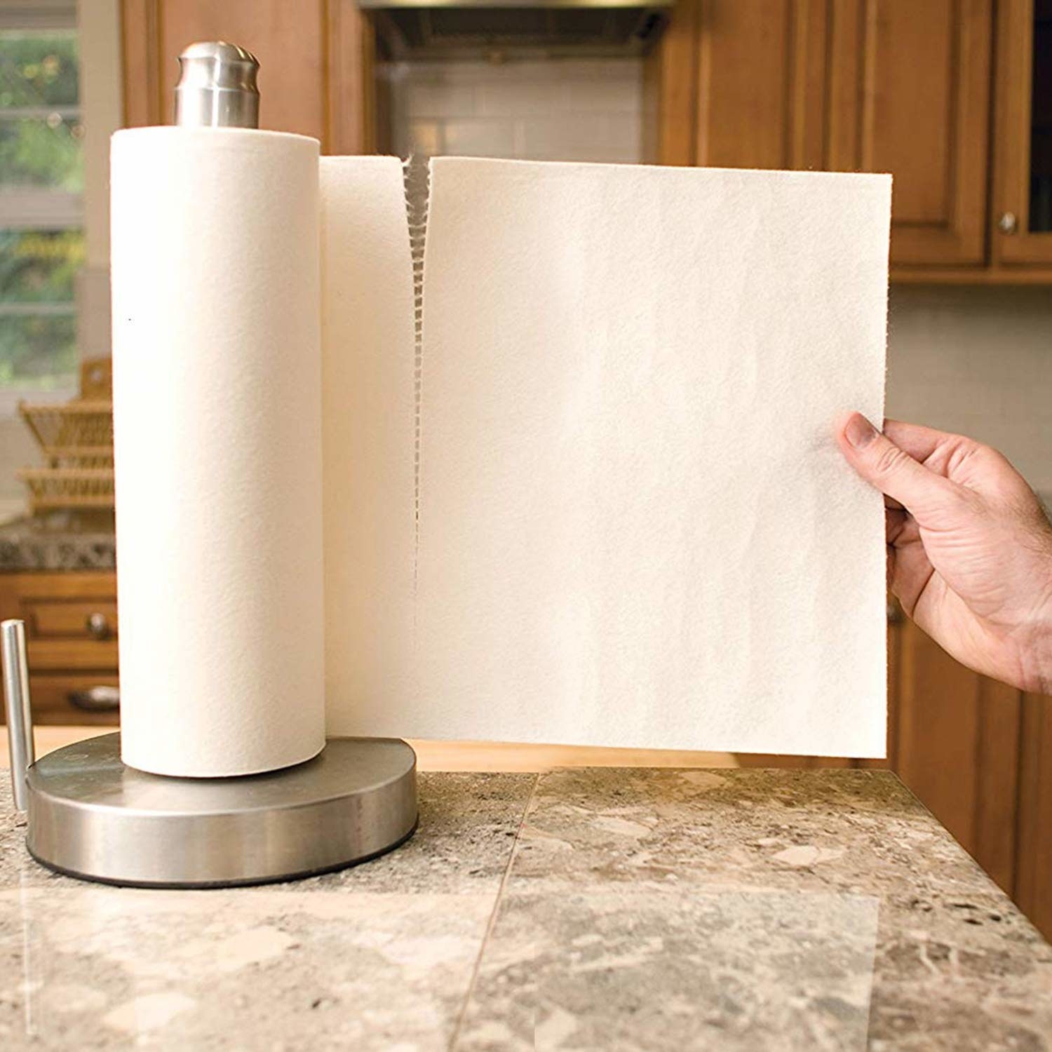 A hand pulling at the bamboo kitchen towel 