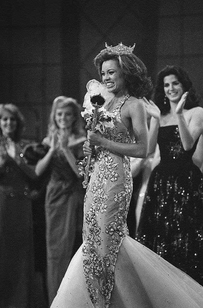 Crowned the new Miss America 1984, Miss New York, Vanessa L. Williams beams as she is applauded by runners-up Miss Virginia, Lisa Aliff (left), and Miss Ohio, Pamela Rigas (right)