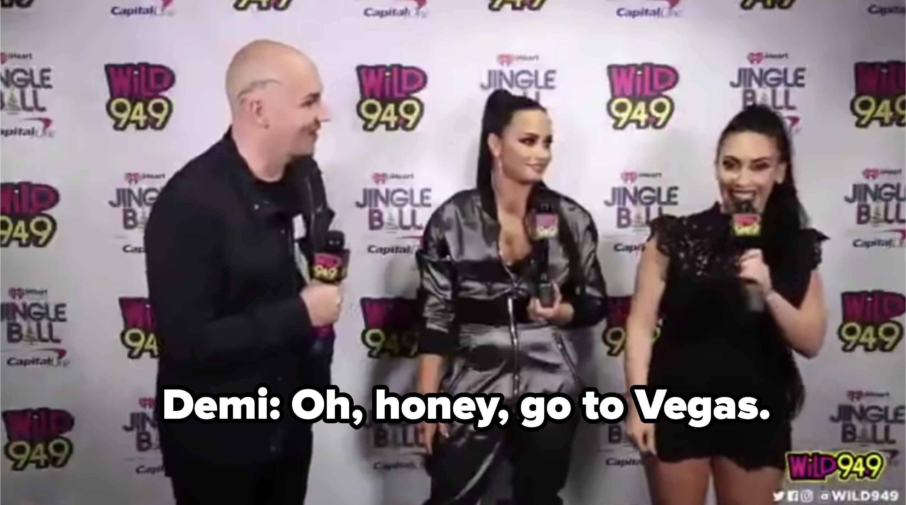 Demi Lovato getting interviewed on a red carpet 