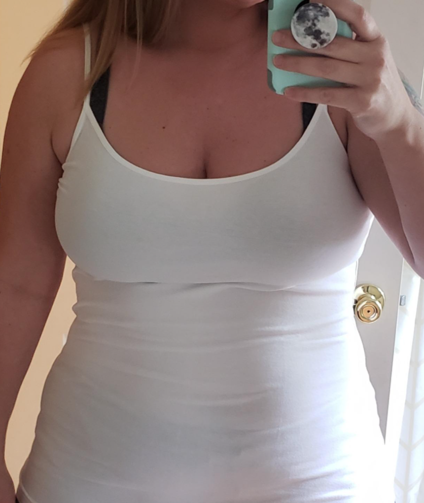 A reviewer wearing the tank top in white