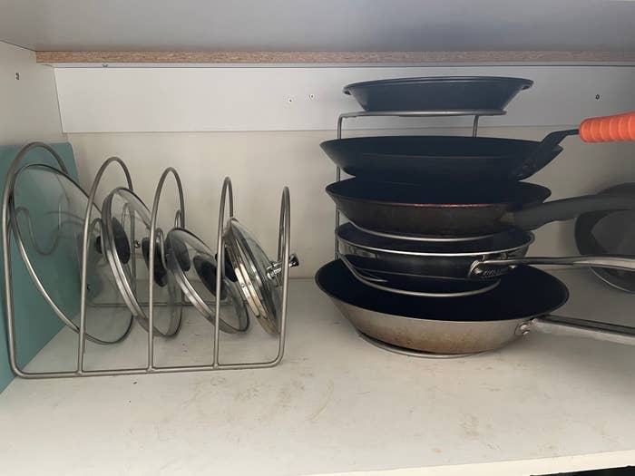 The pan racks with lids in one and skillets in the other 