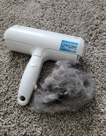 the pet hair roller next to a clump of fur that it cleaned up