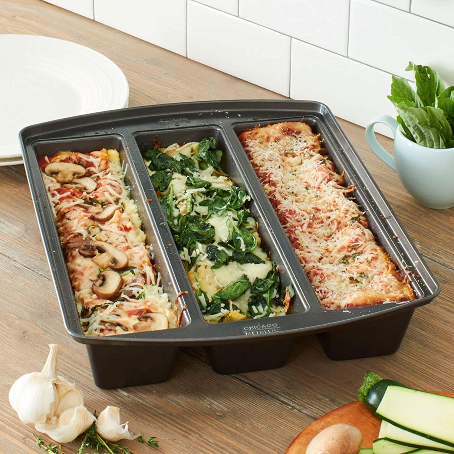 The pan with three rectangles of different lasagna in it 