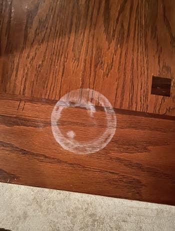 a white watermark on a reviewer's wooden table