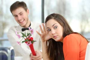 woman looking disgusted by a dude holding flowers