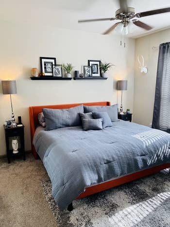 reviewer's photo of the burnt orange upholstered bed frame