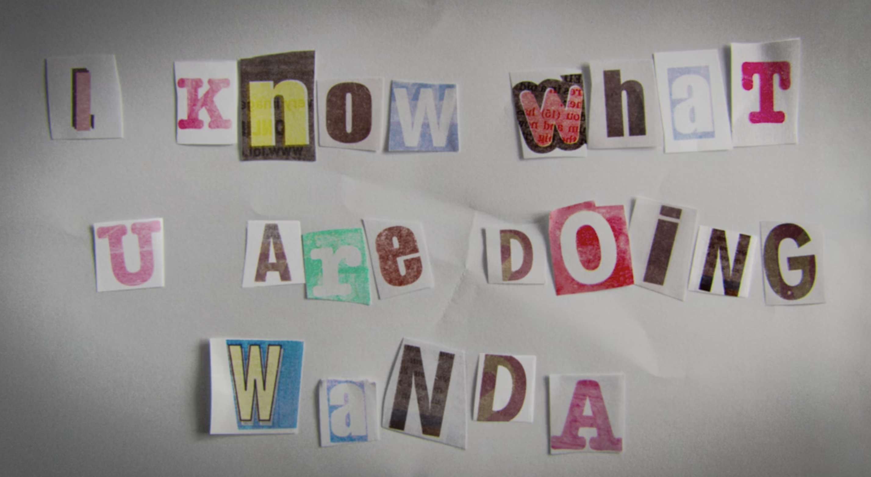 Cutouts of letters with different fonts that spell out, &quot;I know what U are doing Wanda&quot;